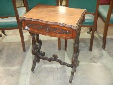 A Victorian mahogany sewing table with ornate legs