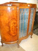A fine walnut serpentine fronted display cabinet