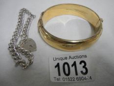 A silver charm bracelet with Birmingham hall mark and a rolled gold bracelet