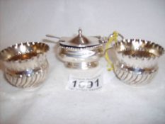 A pair of silver salts and a silver mustard pot with spoon, approx.