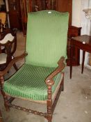 A 19th century oak arm chair with rush seat and upholstered cushion