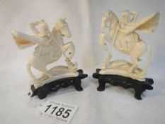 A pair of ivory figures of knight slaying dragon