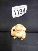 A signed ivory netsuke of a frog