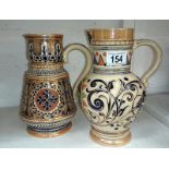 An ornate stoneware Doulton Lambeth style jug and one other