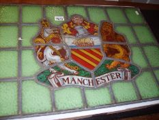 An unusual stained and leaded glass 'Manchester Heraldic' window pane