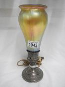 An early 20th century table lamp with lustre glass shade in the style of Tiffany