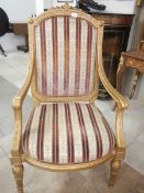 A good giltwood armchair with regency striped upholstery