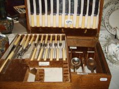 An oak cased Walker and Hall part canteen of cutlery