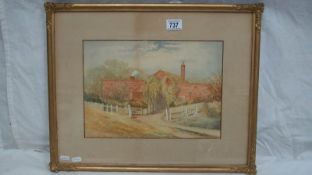 An early 20th century framed and glazed watercolour painting of farm buildings