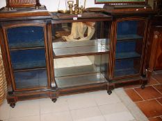 A Victorian ebonised and burr walnut cabinet with central open shelves and glazed cupboards at each