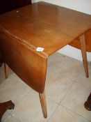 A light oak drop side Ercol style table