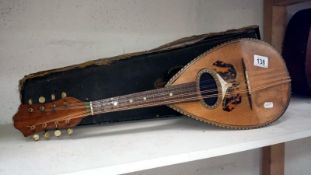 A Victorian mandolin with inlaid tortoise shell butterfly and complete with case