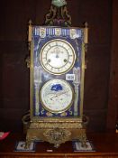 A French brass mantel clock with hand painted decoration and 2 dials