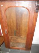 A Victorian mahogany wall hanging cabinet with glazed door