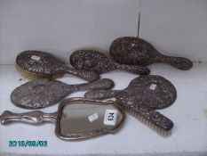 4 silver backed hand mirrors and 3 silver backed brushes,