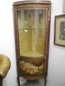 A fine French 20th century French bow fronted corner cabinet with hand painted scene and ormolu