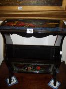 A Russian lacquered magazine rack with Troika sleigh scene to top surface and other painted scenes