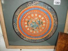 A 19th century framed and glazed Chinese circular silk panel