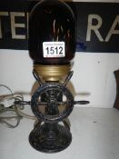 A cast iron table lamp in form of a ship's wheel