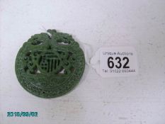 A carved jade medallion