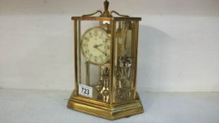 A Kundo 400 day anniversary clock in brass case with porcelain face, approx. 9.