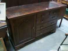 A 1930's oak side cabinet with 2 end cupboards and 5 drawers