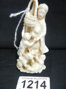 An ivory Okimono of Lady with children and animals,