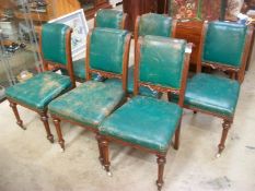 A set of 6 Victorian mahogany framed green leather dining chairs