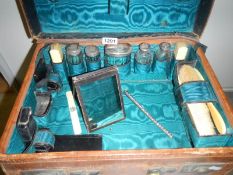 A Victorian ladies vanity case complete with silver topped bottles, 2 inkwells, ivory items etc,