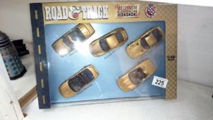 A boxed road and track millenium edition 2000 gold plated die cast car set