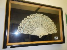 A framed and glazed fan
