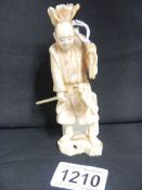 An ivory Okimono of a farmer