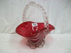 A beautiful hand made cranberry glass basket