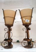 A pair of gilded wrought iron lamps