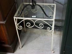 A small wrought iron glass topped table