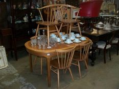 A set of 6 Ercol dining chairs and a suitable extending dining table