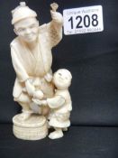 An ivory Okimono of a man holding a lotus and boy with red seal