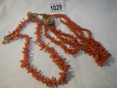 2 antique 'stick' coral necklaces (3 stand and single strand with silver clasp)