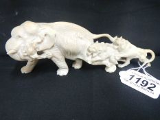 An ivory figure of an elephant being attacked by lions (leg a/f)