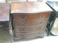 A mahogany serpentine front medium 4 drawer chest