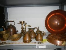 A Victorian copper mould, graduated copper jugs,