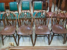 A set of 4 oak wheel back dining chairs