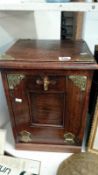 An Edwardian oak coal box with brass mounts