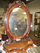 A large Victorian mahogany toilet mirror