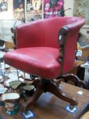 A red leather covered adjustable captain's chair