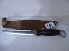 A scouting knife and sheath,