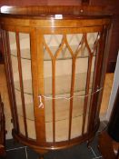 A good quality bow fronted display cabinet with 3 glass shelves