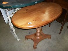 A tripped and waxed oval pine side table