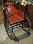 A late 19th early 20th century hand propelled invalid carriage