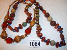 A natural stone bead necklace and one other